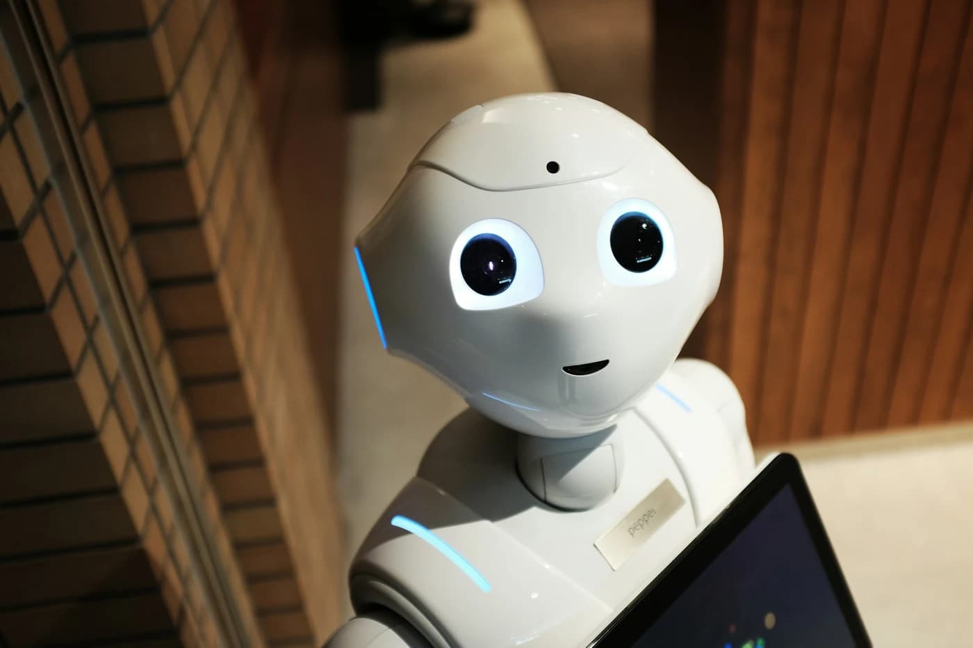 Friendly assistant robot holding a tablet
